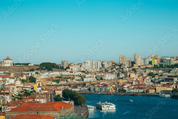 Obraz Panoramic view of Porto cityscape from gardens of Palacio de Cristal with traditional houses, Douro river with boats navigating and Serra do Pilar Monastery on a sunny day with blue sky. Portugal.