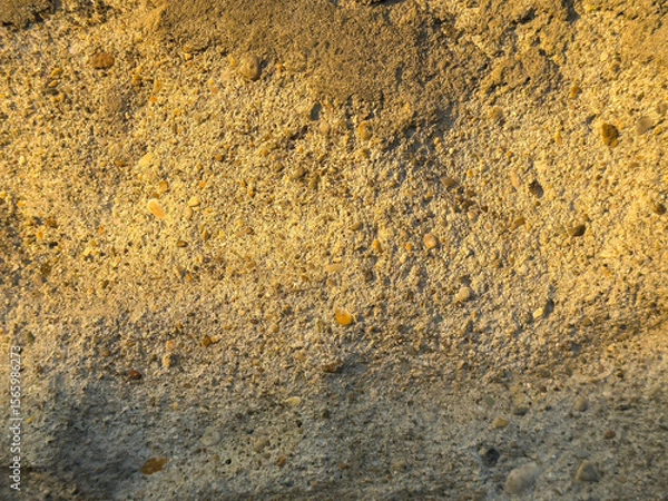 Fototapeta Textured surface of old weathered concrete wall with small pebbles