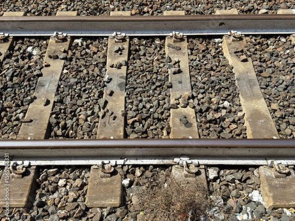 Fototapeta Close-up of railway tracks with gravel ballast and metal rails