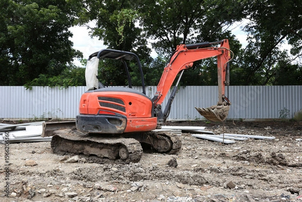 Obraz Excavator on earthworks on construction area of industrial building in construction site.Earthmoving construction equipment