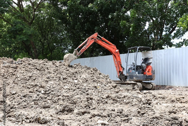 Obraz Excavator on earthworks on construction area of industrial building in construction site.Earthmoving construction equipment