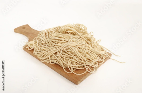 Obraz raw ramen noodle in wood cutting board isolated on white background. fresh egg ramen noodle isolated on white background. Japanese food ramen noodle isolated on white background. copy space