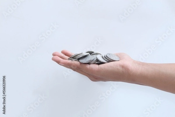 Fototapeta Coins in hand. Saving money. Saving money