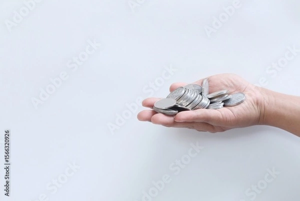 Fototapeta Coins in hand. Saving money. Saving money