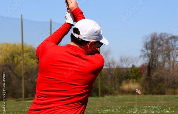 Obraz Golfer Practicing Swing at an Outdoor Driving Range