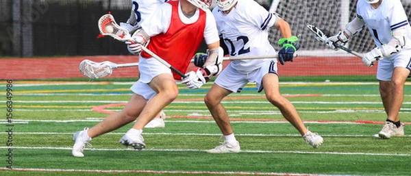 Obraz High School Players Engage in Intense Lacrosse Match on a Turf Field