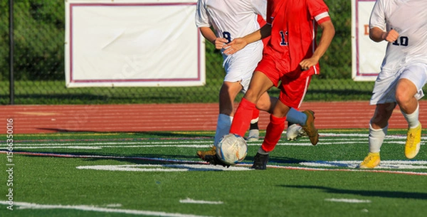 Obraz Players Compete in an Intense Soccer Match on a Summer Afternoon