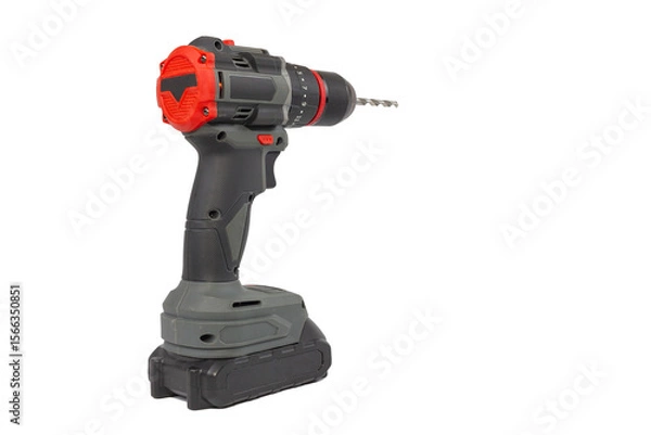 Fototapeta A cordless drill stands upright against a plain white background, showcasing its gray and black body, red accents, and a metal drill bit inserted into the chuck.