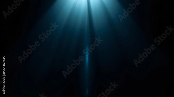 Fototapeta A focused beam of light creating a dramatic and mysterious atmosphere on a dark background.