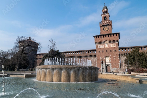 Obraz The iconic Torre del Filarete at Sforza Castle in Milan, Italy, captured under the sunlight. The fortress-like structure showcases Renaissance architecture with brick masonry, arched windows, and defe