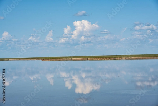 Fototapeta lake with clouds and sky reflected in the water