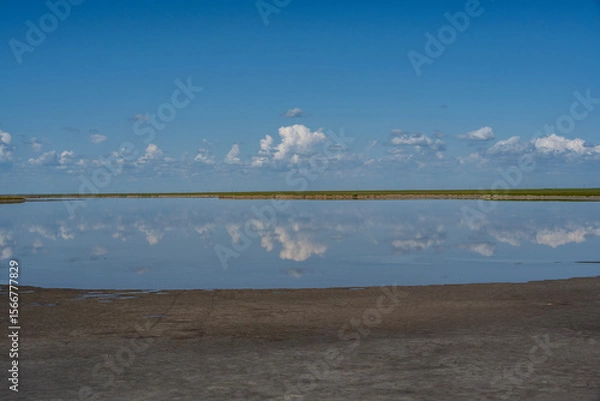 Fototapeta lake with clouds and sky reflected in the water