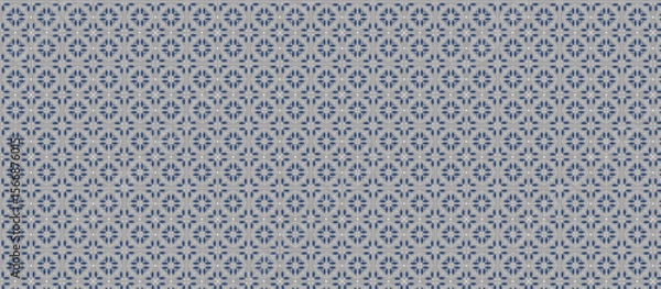 Fototapeta Repeating Grid Pattern of Small Geometric Floral Motifs in Dark Gray and Off-White on Light Gray Background with Visible Grout Lines, Creating a Subtle Tessellation Tile Effect for Decorative Use
