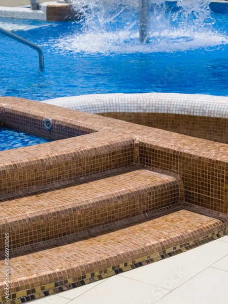 Fototapeta Tiled Steps into Resort Pool
