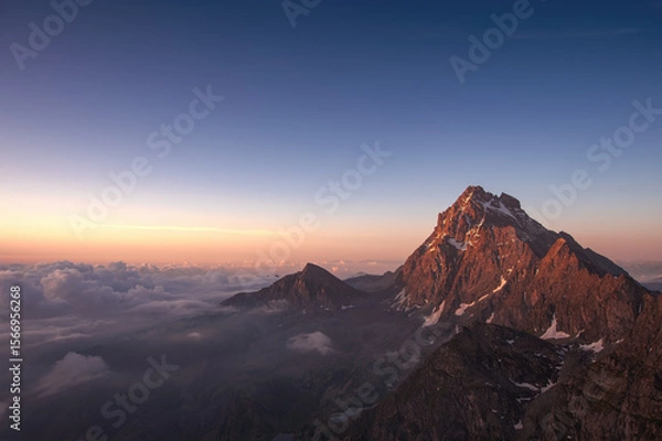 Fototapeta Monviso (Mount Viso or simply Viso), the highest mountain in the cottian Alps, standing out in the intense colors of a summer dawn. Italian Alps, July.