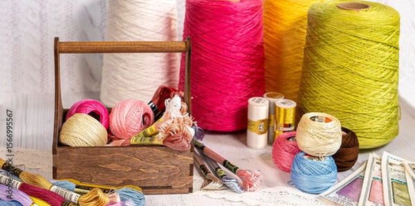 Fototapeta Threads in reels. Colored bobbins for embroidery knitting hobby accessories creativity.