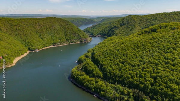 Obraz Aerial view of Tarnita Lake surrounded by forested hills