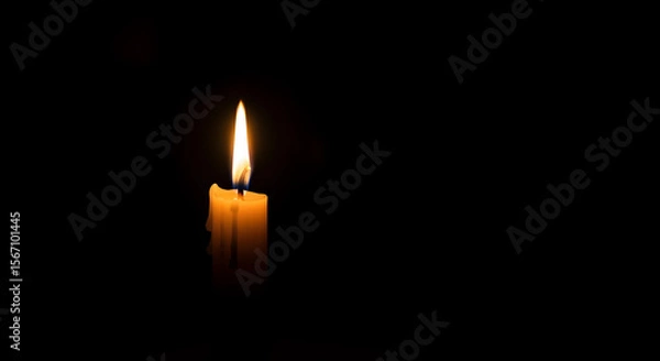 Obraz burning candle on a dark background