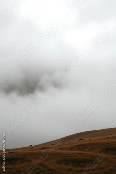 Fototapeta Brown Grass Hillside under Dense Sky Haze, Atmospheric Landscape shot