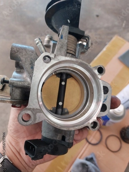 Fototapeta Car engine repair showing throttle body cleaning, sensor inspection, and spark plug maintenance during regular vehicle servicing