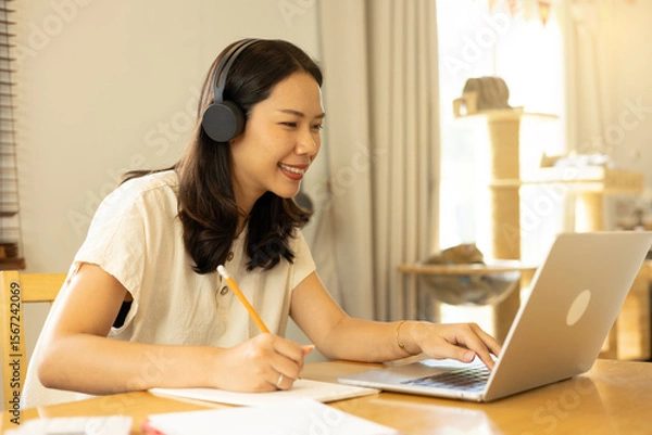 Fototapeta close up young asian woman look on laptop and open website to working online with foreigner colleagues or  check data analysis in home office for lifestyle concept