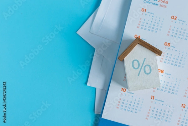Fototapeta close up top view on home model with calculator and invoice mail on blue color background with space for money management ,home loan and personal financial concept