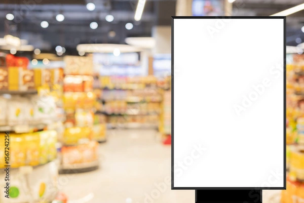 Fototapeta modern blank mockup poster (for ads commercial) standing over blur inside of megastore of local supermarket background in the weekend for billboard design and shopping grocery business concept