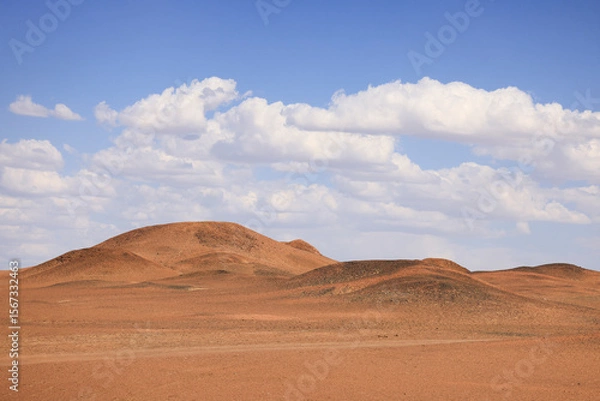 Fototapeta desert landscape with blue sky and clouds