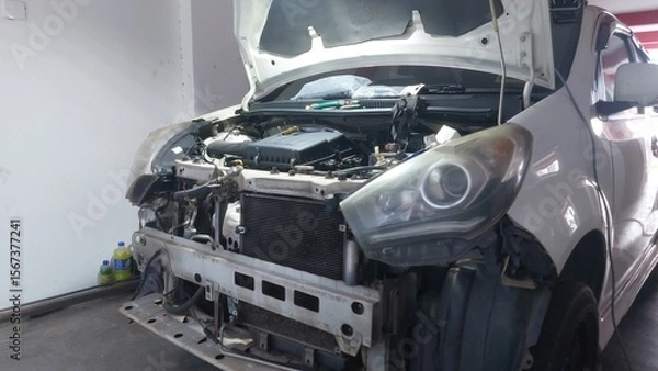 Fototapeta Vehicle repair showing bumper replacement, air filter service, engine components, piston and gasket inspection during mechanical maintenance.