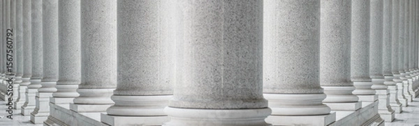 Obraz White marble columns in a neoclassical architectural style. Symmetrical row of classical marble columns, structural repetition, and elegant monumental design