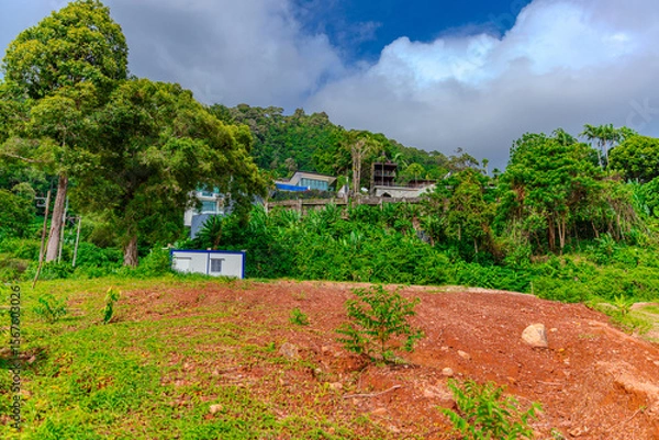 Fototapeta House perched on top of a hill in the mountains of Kalim overlooking the Andaman sea and Patong Beach on the island of Phuket Thailand