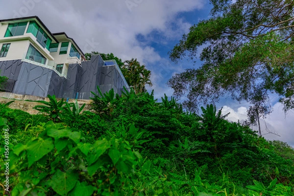Fototapeta House perched on top of a hill in the mountains of Kalim overlooking the Andaman sea and Patong Beach on the island of Phuket Thailand