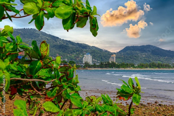 Fototapeta View of Patong Beach in the island of Phuket Thailand, turquoise blue waters of the Andaman and lush green mountains