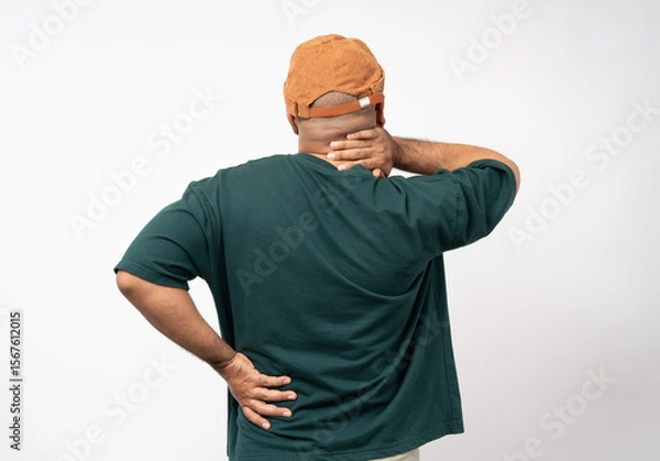 Obraz Young asian man has problem with structural posture He had neck and shoulder pain Massaged his neck and shoulders for relief. reduce muscle tension. Standing on isolated white background