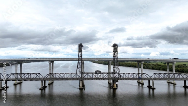 Fototapeta A stunning Aerial View of Pacific Highway Harwood Bridge crosses the Clarence River under a cloudy sky in the Northern Rivers region of New South Wales, Australia 