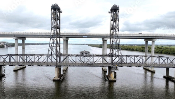 Fototapeta A stunning Aerial View of Pacific Highway Harwood Bridge crosses the Clarence River under a cloudy sky in the Northern Rivers region of New South Wales, Australia 