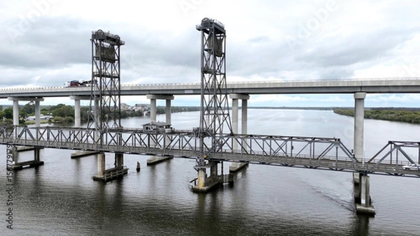 Fototapeta A stunning Aerial View of Pacific Highway Harwood Bridge crosses the Clarence River under a cloudy sky in the Northern Rivers region of New South Wales, Australia 