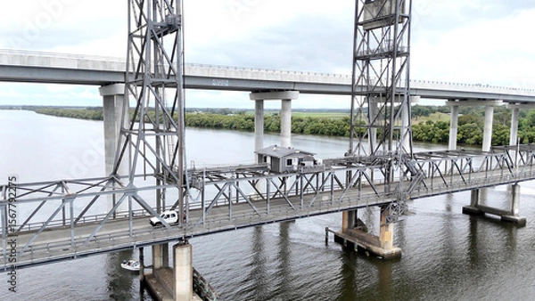 Fototapeta A stunning Aerial View of Pacific Highway Harwood Bridge crosses the Clarence River under a cloudy sky in the Northern Rivers region of New South Wales, Australia 