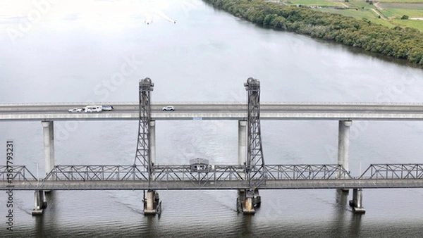 Fototapeta A stunning Aerial View of Pacific Highway Harwood Bridge crosses the Clarence River under a cloudy sky in the Northern Rivers region of New South Wales, Australia 