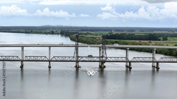 Fototapeta A stunning Aerial View of Pacific Highway Harwood Bridge crosses the Clarence River under a cloudy sky in the Northern Rivers region of New South Wales, Australia 