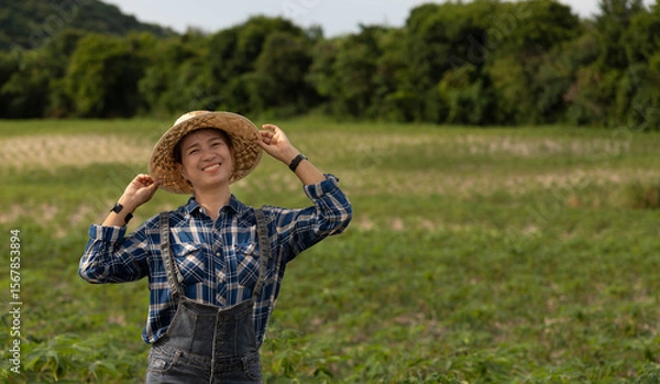 Fototapeta Smiling Farmer Enjoys a Sunny Day in the Field