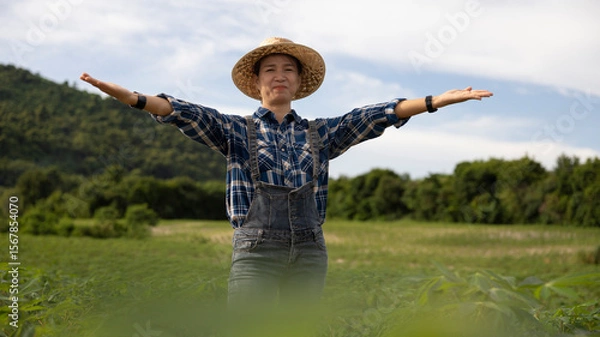 Fototapeta Smiling Farmer Enjoying a Sunny Day in the Field