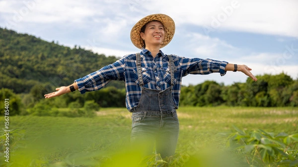 Fototapeta Smiling Farmer Enjoying Nature in Green Fields