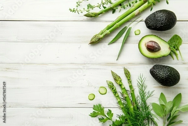 Obraz Green Herbs,Asparagus and Black Avocado on a White Wooden Background Top View Flat Lay