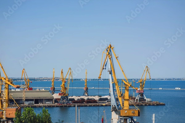 Obraz Seaport infrastructure in Odessa, Ukraine. Cargo cranes, terminals and port warehouses on the Black Sea coast.