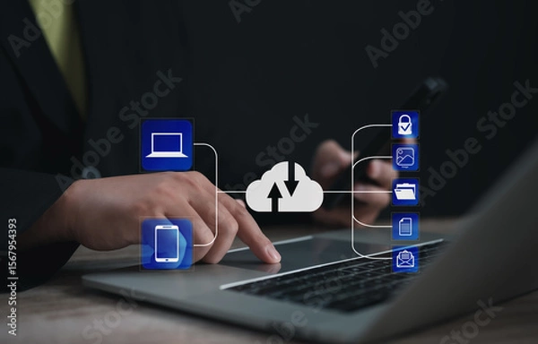 Fototapeta Entrepreneur syncing data between laptop and smartphone through cloud system, with secure icons for image, folder, file, and email, representing seamless digital integration and backup.