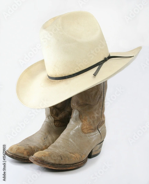 Obraz Worn cowboy boots with straw hat