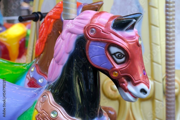 Fototapeta Vivid carousel horse adorned with jewels in a lively amusement park