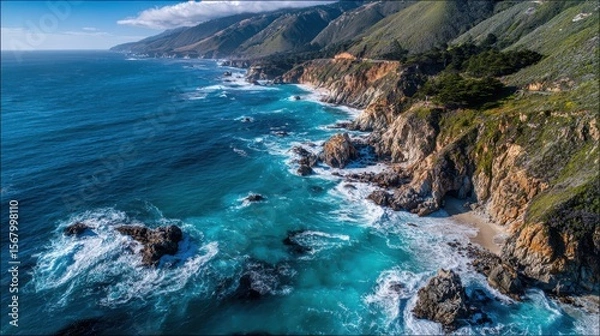 Fototapeta Scenic coastline features rugged cliffs turquoise ocean waters and mountainous terrain with greenery