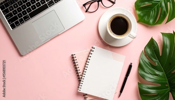 Fototapeta Flat lay photo of modern business tools like laptop, notebook, pen, glasses, and coffee cup arranged around empty space in the center, solid pastel background